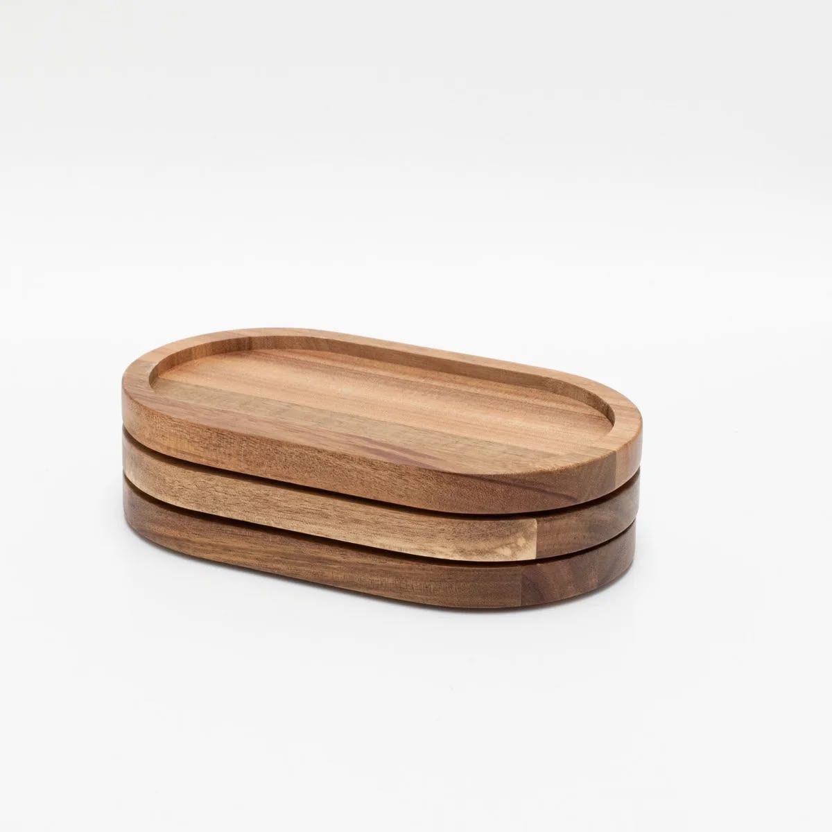 Two oval acacia wood trays stacked